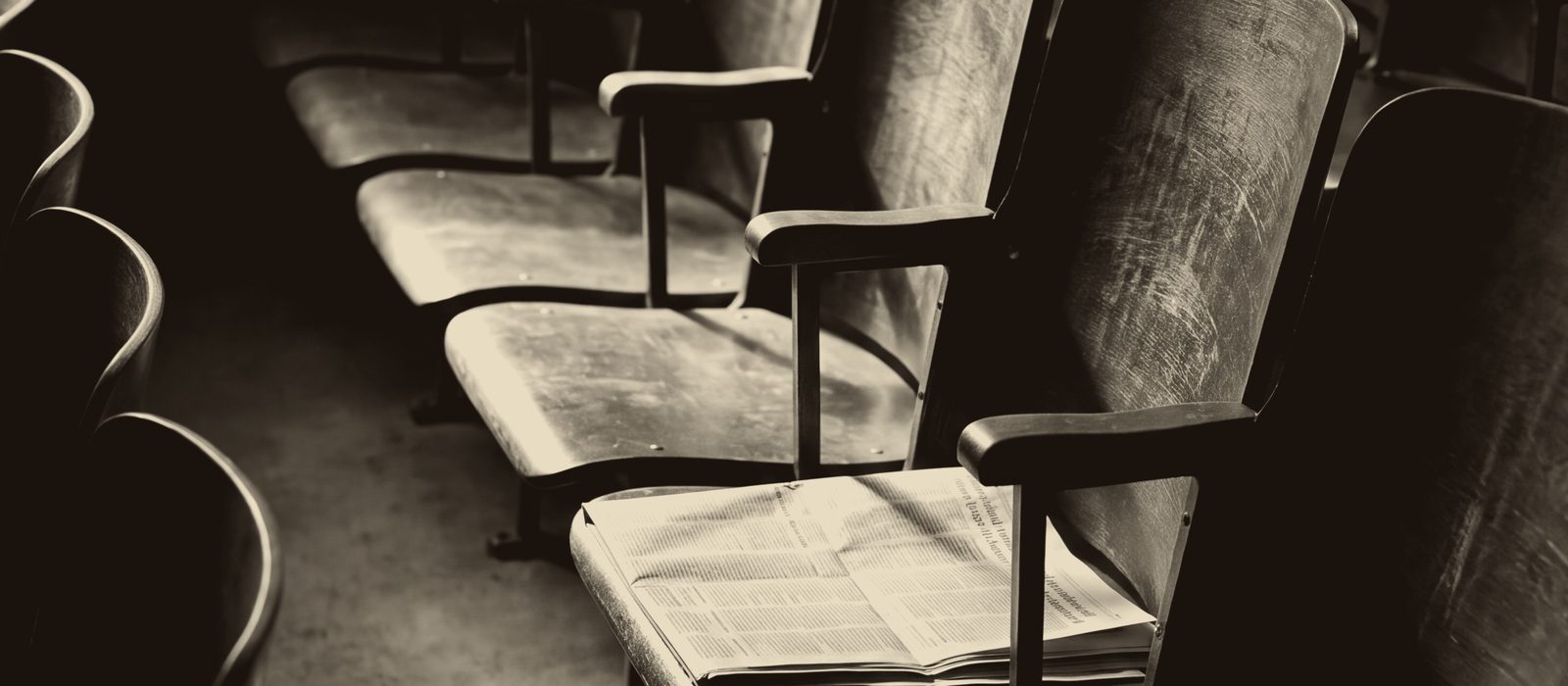 Empty lecture hall seats with an open paper, from the ETG GP art bank